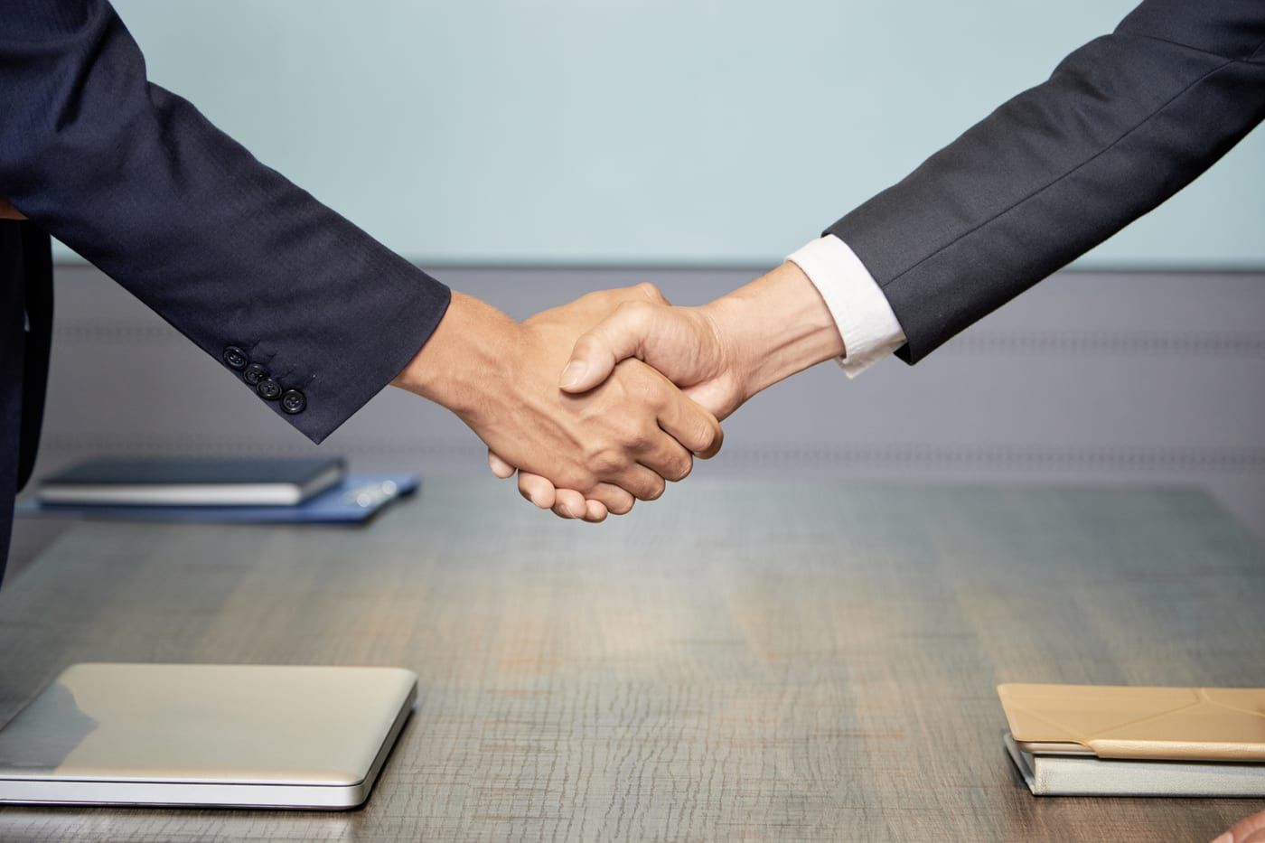 Two business professionals shaking hands to close a deal