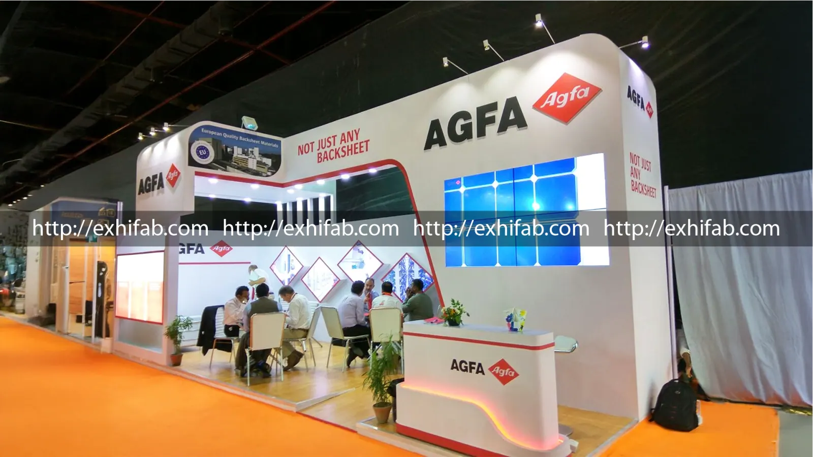 AGFA exhibition stall with red diamond branding, diamond-shaped product displays and a backlit solar panel at a renewable energy expo