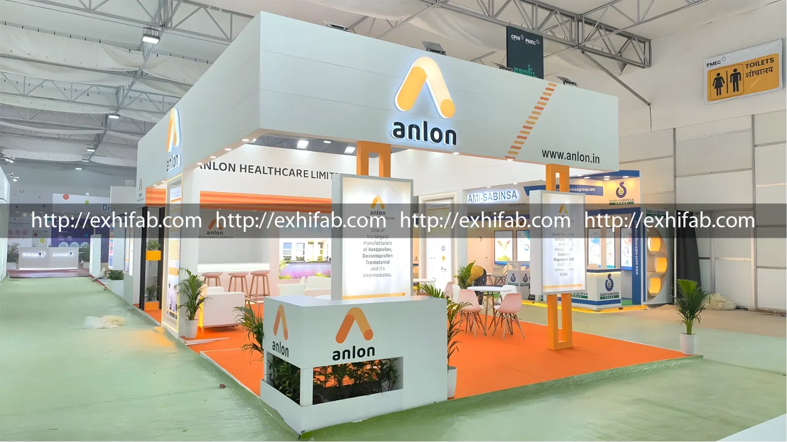 Anlon Healthcare exhibition stall with illuminated orange logo, product panels and landscaped seating at CPHI PMEC India