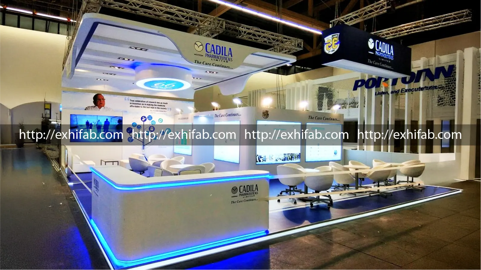 Cadila Pharmaceuticals double-decker exhibition stand with sweeping curved canopy, blue LED accents and interactive screens