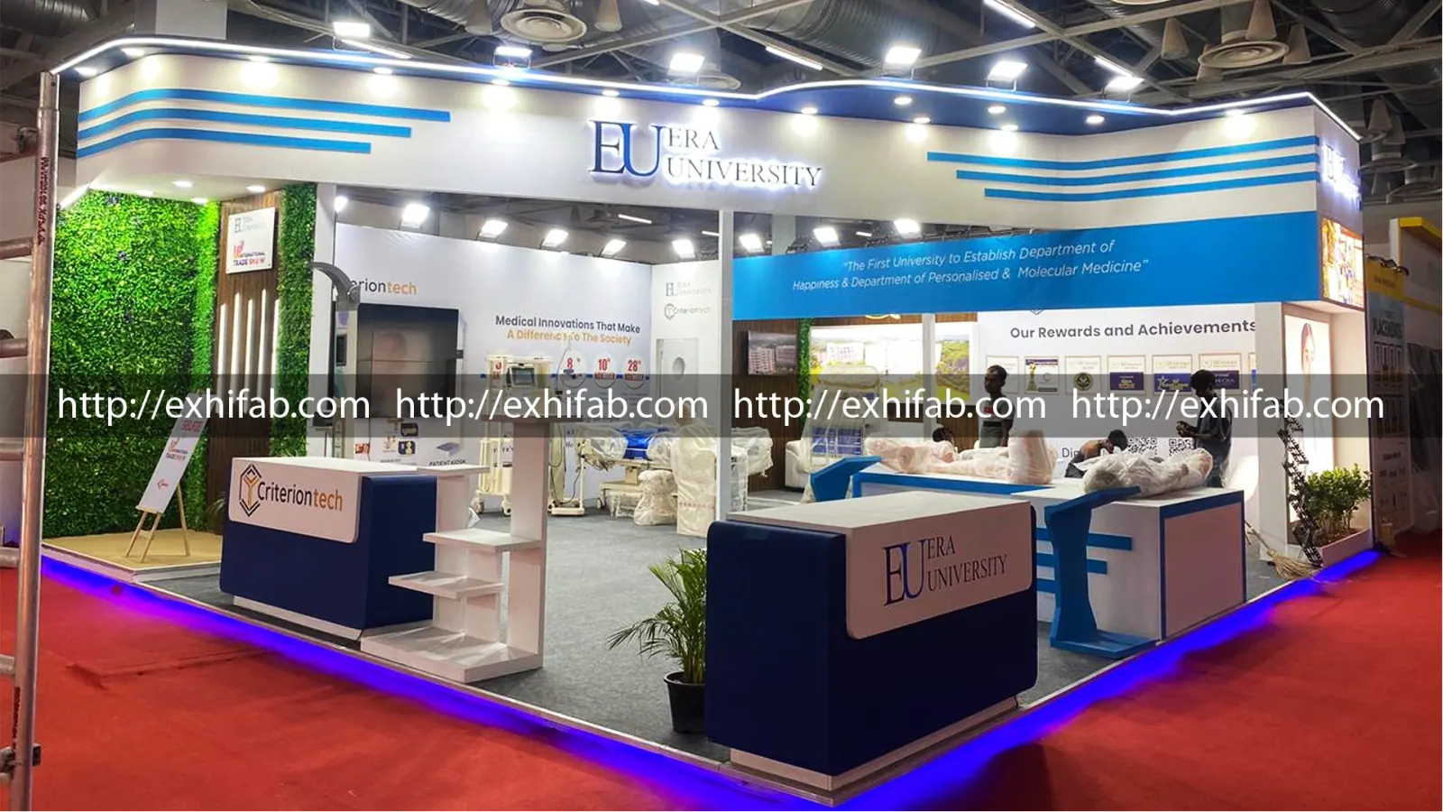Era University exhibition stall with blue-and-white branding, green living wall, medical innovation displays and awards showcase