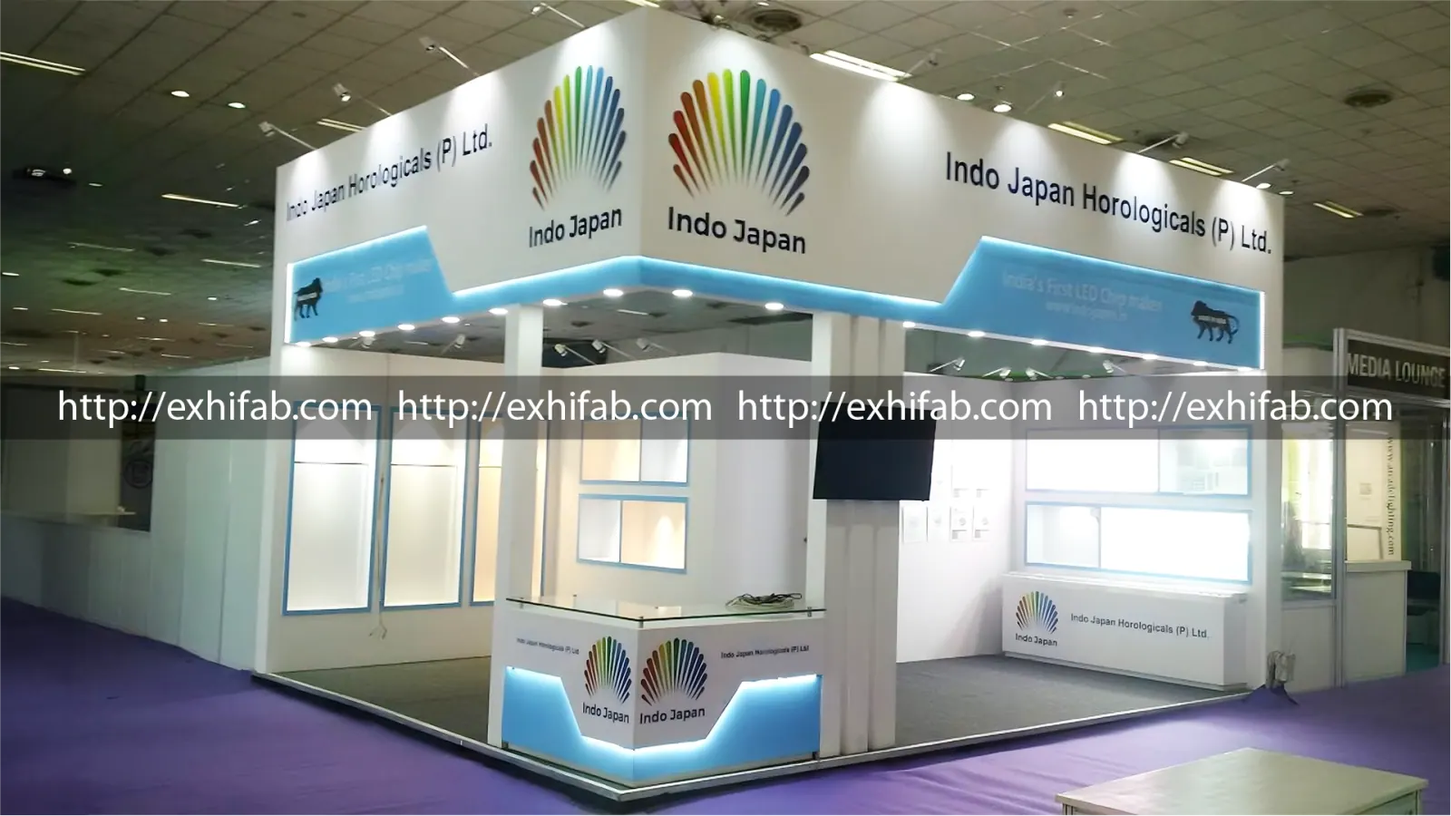 Indo Japan Horologicals corner exhibition stall with cyan LED edge lighting and product display windows at LED Expo